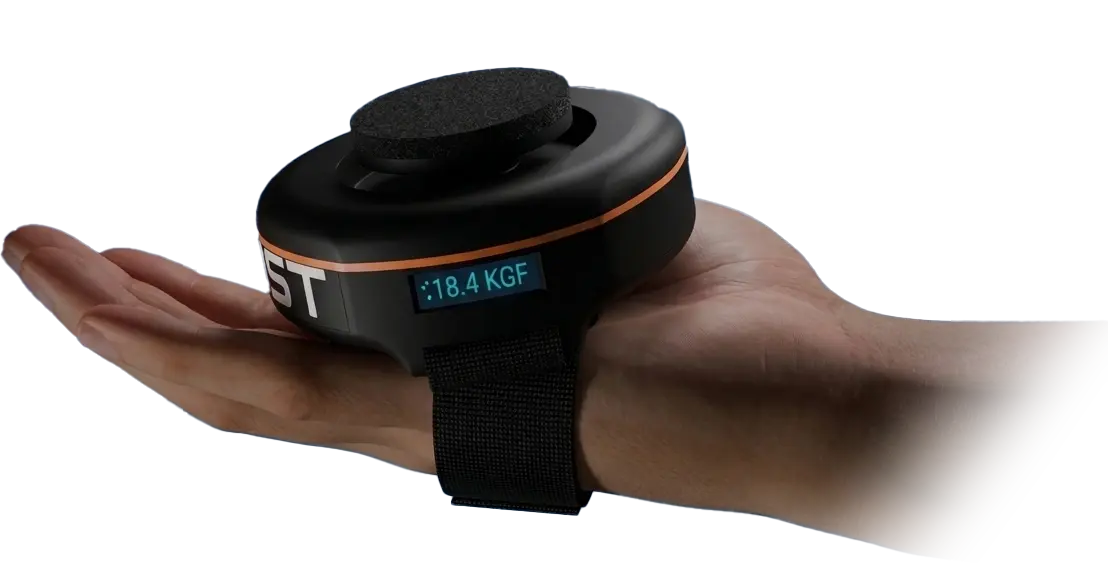 Fitmust dynamometer resting in open palm showing 18.4 KGF on display